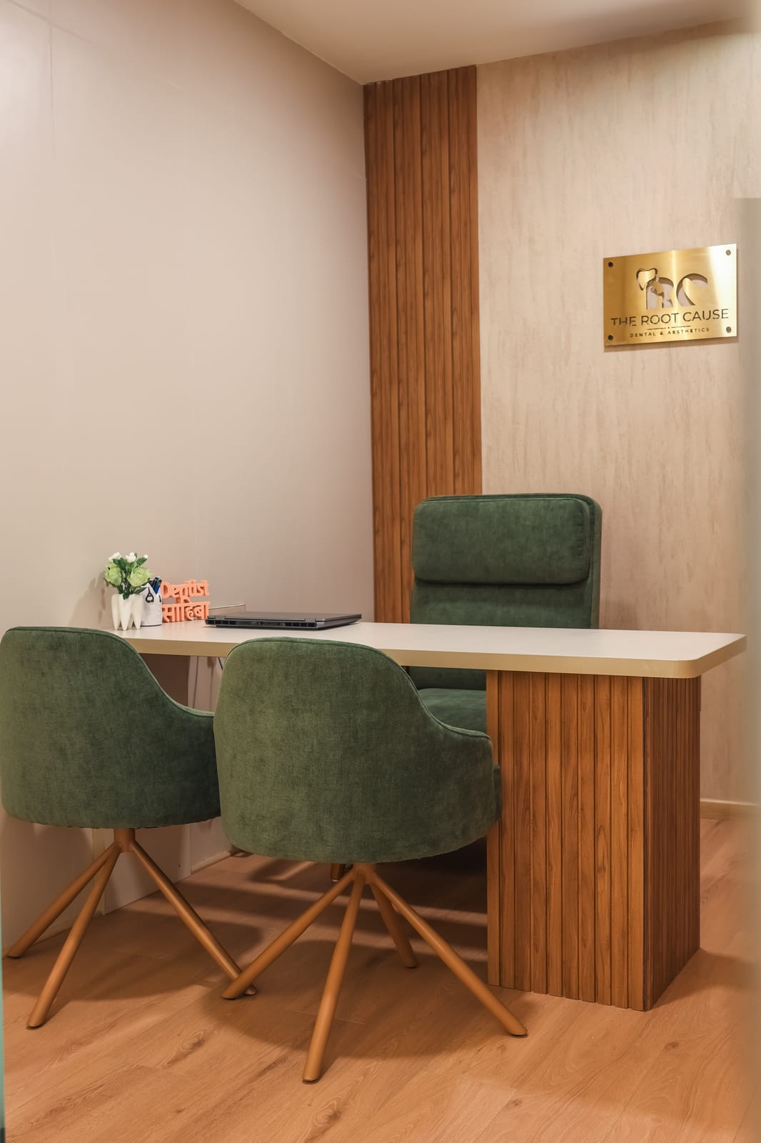 Consultation room with a desk and green chairs