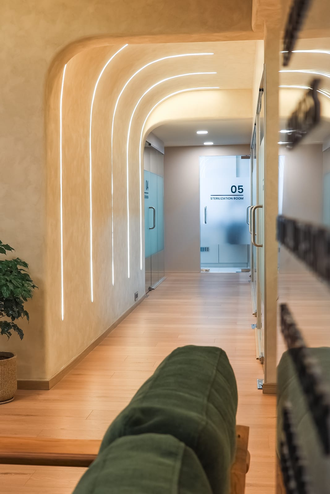 Arched, softly lit corridor leading to the treatment rooms