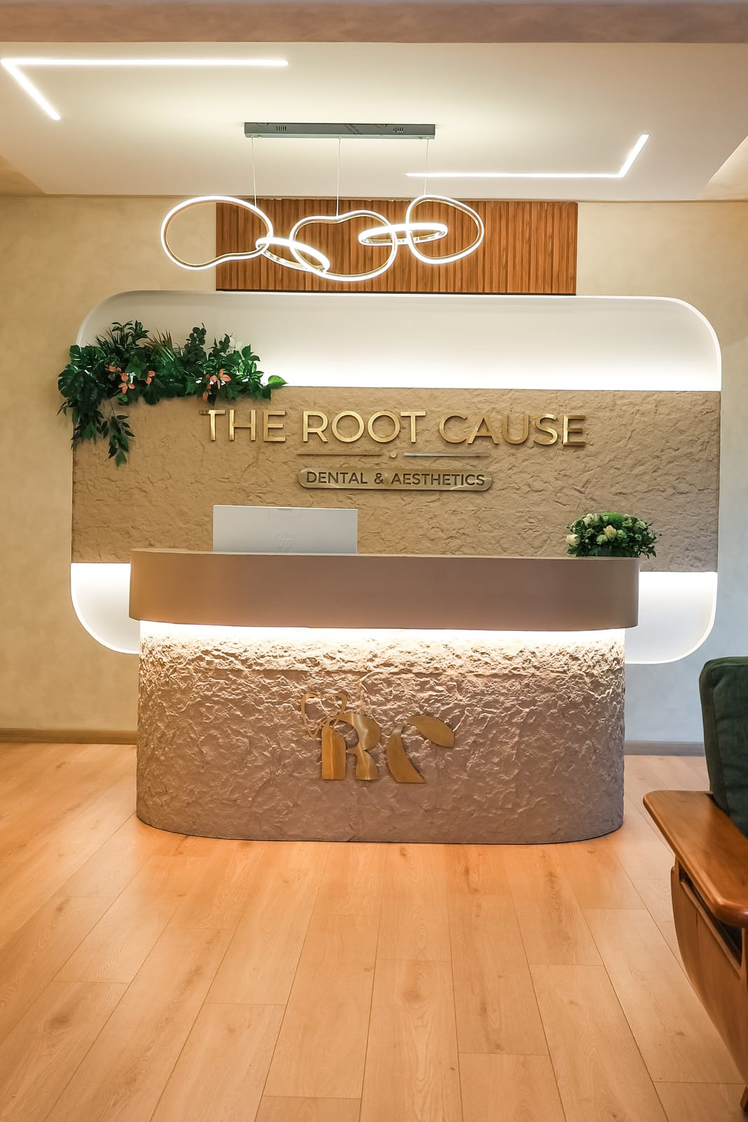Reception desk beneath The Root Cause sign